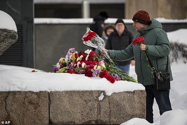 Russia begins jailing hundreds of protesters for laying flowers and candles in memory of